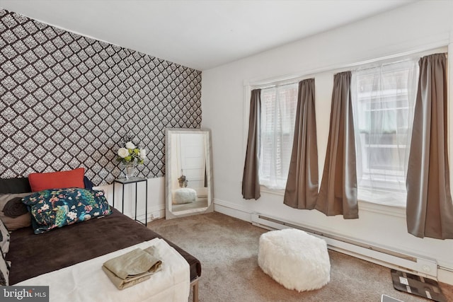 carpeted bedroom featuring baseboards, baseboard heating, an accent wall, and wallpapered walls