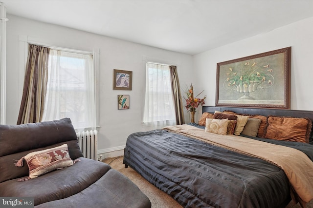 bedroom featuring radiator and baseboards