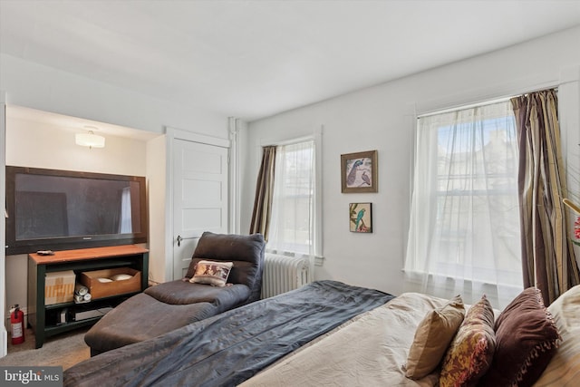 carpeted bedroom featuring radiator heating unit