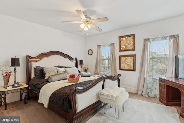 bedroom with light carpet and ceiling fan