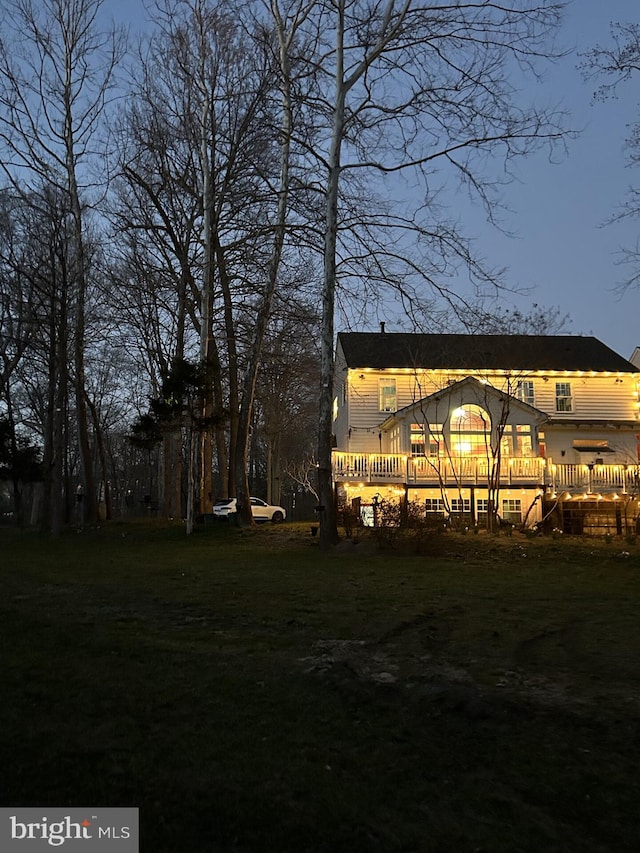 rear view of property featuring a yard