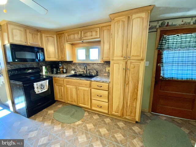 kitchen featuring tasteful backsplash, a sink, black appliances, and light brown cabinetry