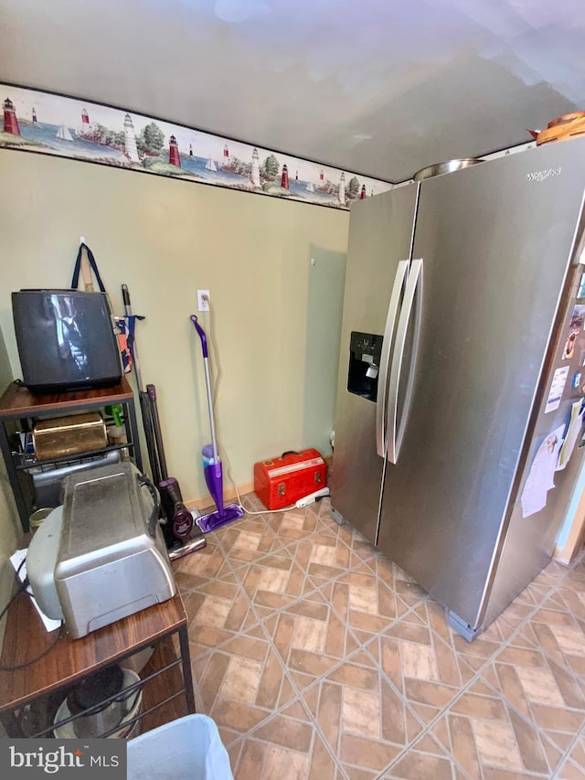 kitchen featuring stainless steel fridge with ice dispenser