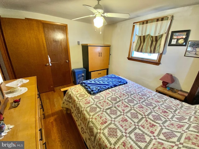 bedroom featuring a ceiling fan and wood finished floors