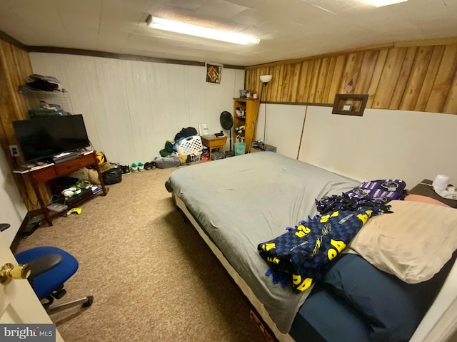 carpeted bedroom with wooden walls