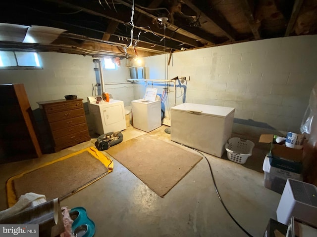 basement featuring independent washer and dryer and fridge