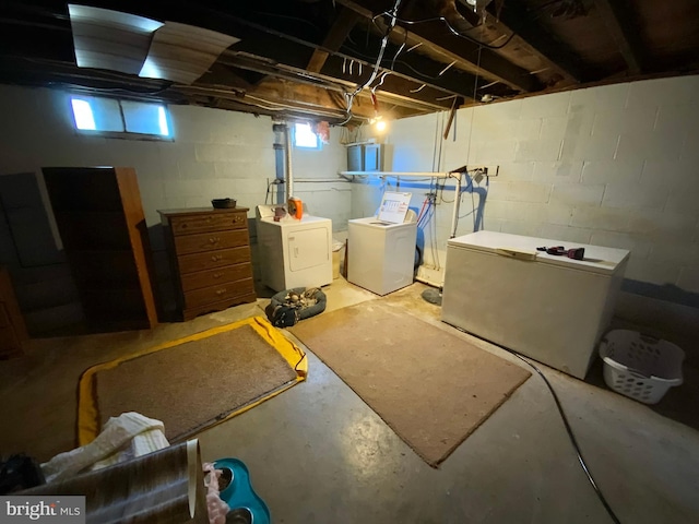 below grade area with fridge and washer and clothes dryer