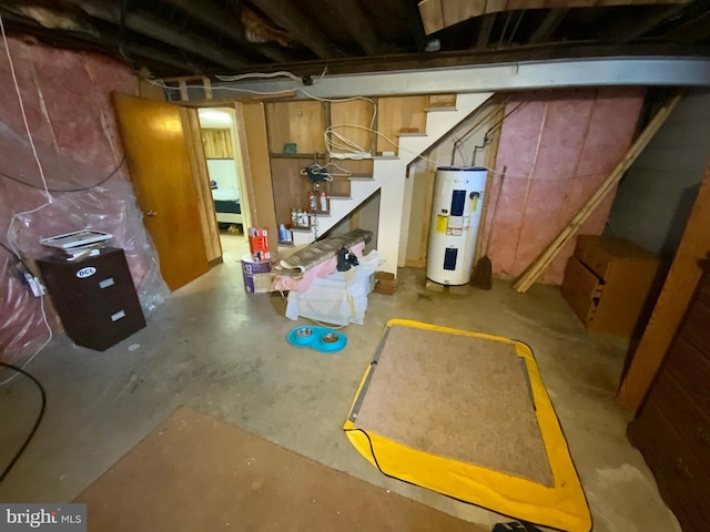 unfinished below grade area featuring electric water heater and stairs