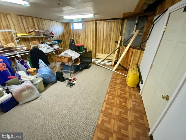 basement featuring wood walls