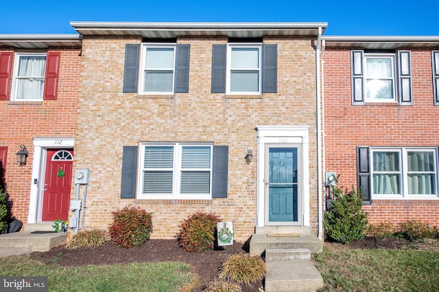 view of property featuring brick siding