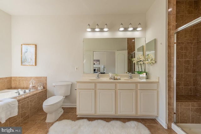 full bathroom with a garden tub, a sink, tile patterned floors, double vanity, and a stall shower