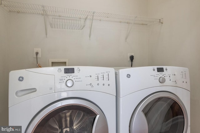 clothes washing area with laundry area and washing machine and dryer