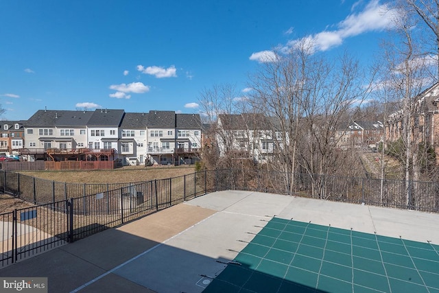 view of patio with a residential view and fence