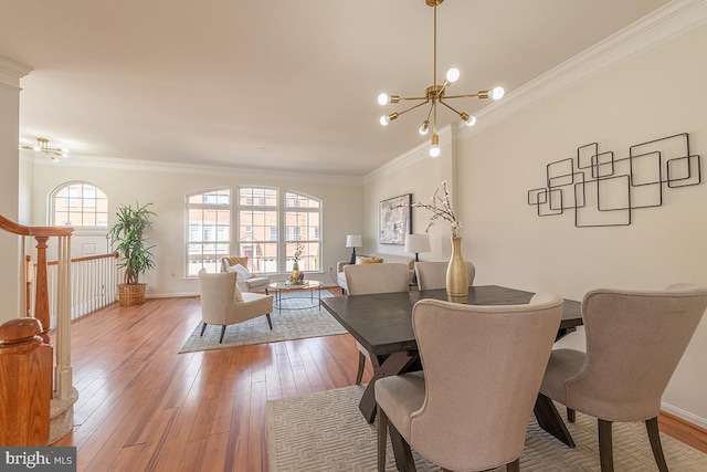 dining room featuring ornamental molding, a notable chandelier, and hardwood / wood-style flooring