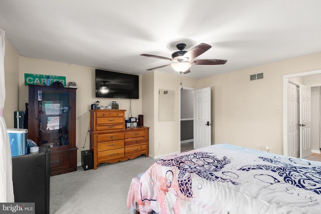 bedroom featuring carpet flooring, baseboards, visible vents, and ceiling fan