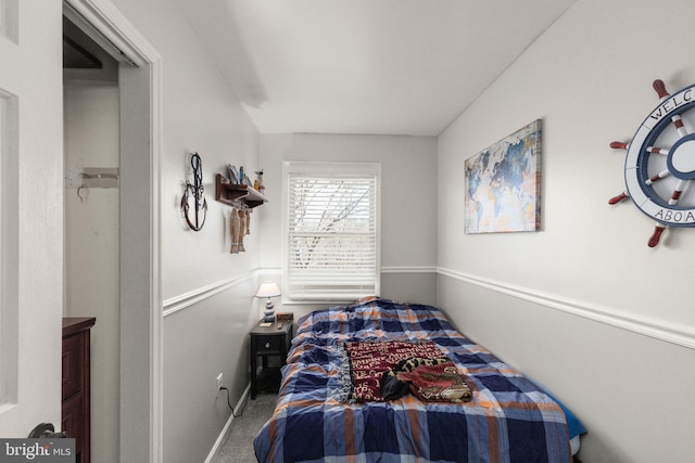 bedroom featuring baseboards and carpet floors