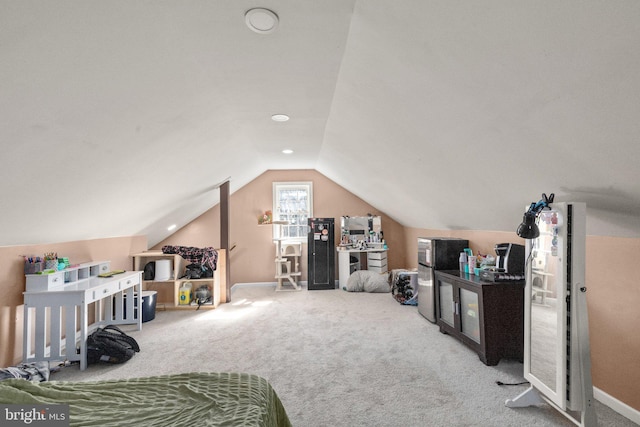 carpeted bedroom with baseboards and vaulted ceiling