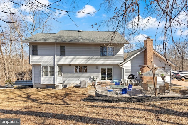 back of property with central AC unit and a patio area