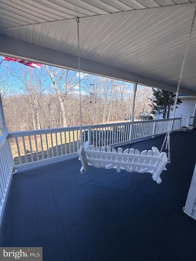 view of patio / terrace with a deck and a forest view