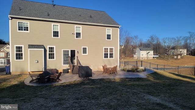 back of house with a patio, a lawn, roof with shingles, and a fenced backyard