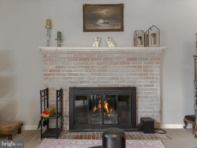 details featuring carpet flooring, baseboards, and a fireplace