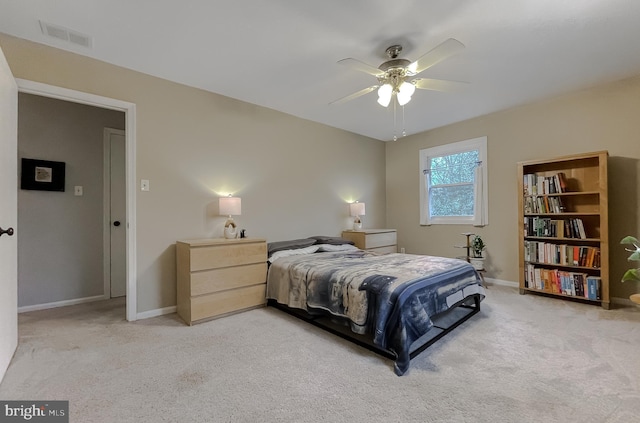 bedroom with light carpet, visible vents, a ceiling fan, and baseboards