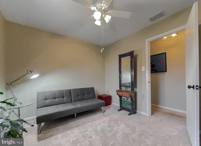 living area featuring visible vents, carpet flooring, a ceiling fan, and baseboards