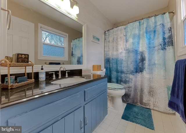 full bathroom featuring tile patterned flooring, toilet, and vanity