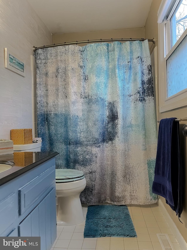 full bathroom featuring tile patterned flooring, visible vents, toilet, and vanity