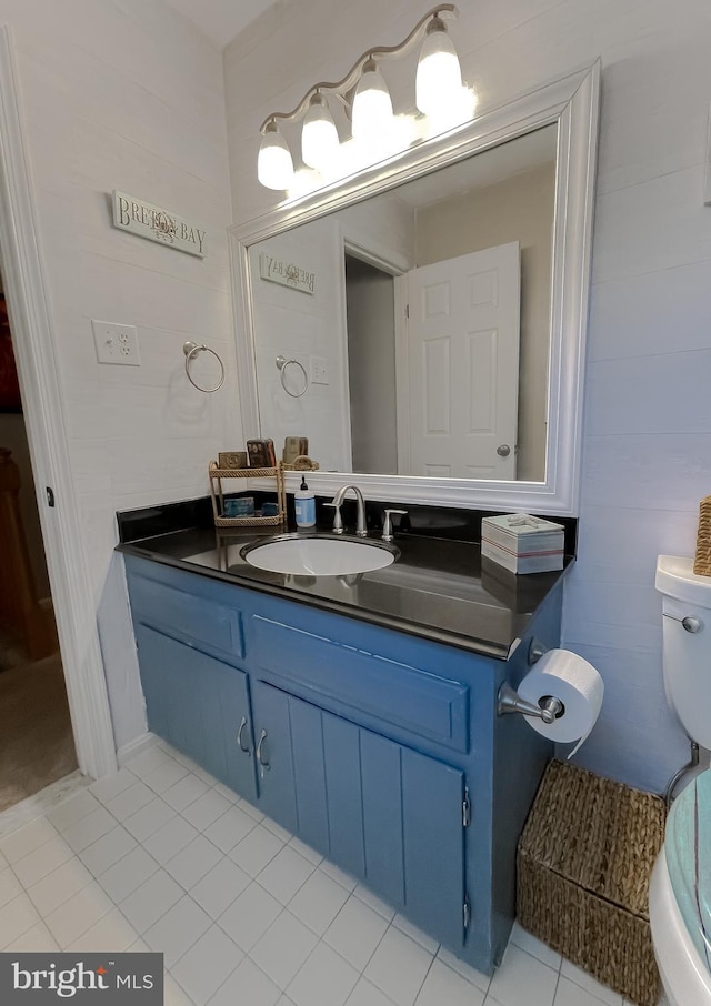 bathroom with vanity, toilet, and tile patterned flooring