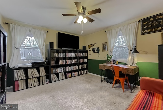 home office featuring carpet flooring, a ceiling fan, and a wealth of natural light