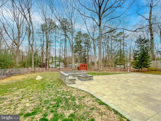 view of yard with a patio, a fire pit, and a fenced backyard