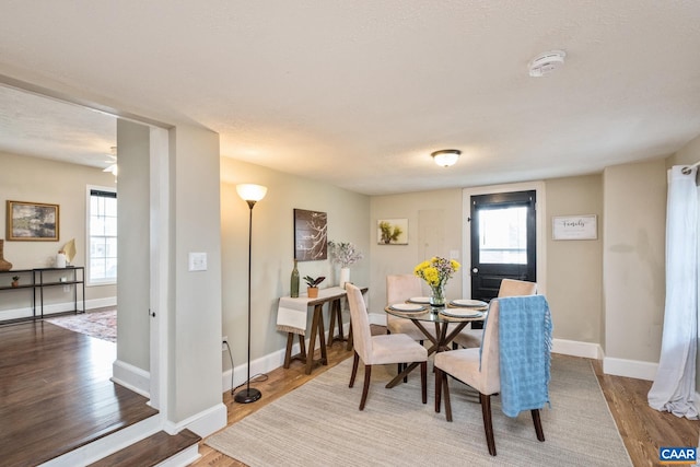 dining room featuring wood finished floors and baseboards