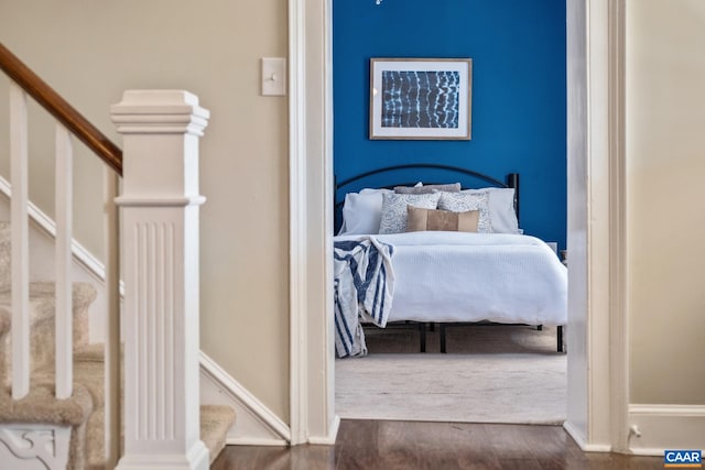 bedroom with baseboards and wood finished floors