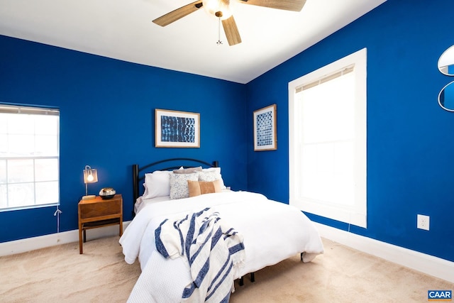 bedroom featuring carpet floors, baseboards, and a ceiling fan