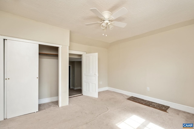 unfurnished bedroom with baseboards, a closet, and light colored carpet