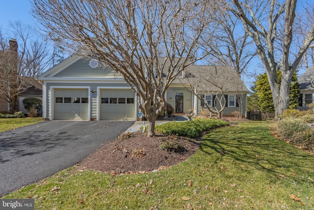 view of front facade with a garage, driveway, and a front lawn