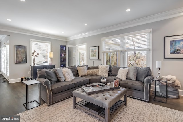 living room featuring baseboards, ornamental molding, wood finished floors, and recessed lighting