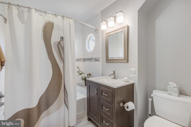 bathroom with toilet, shower / bath combo with shower curtain, and vanity