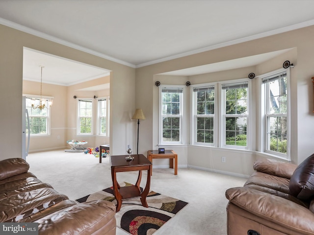 living area featuring carpet floors, ornamental molding, baseboards, and an inviting chandelier