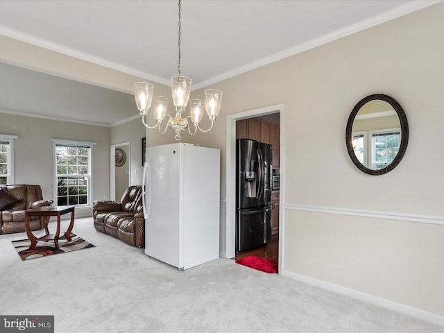 dining area featuring carpet floors, a notable chandelier, baseboards, and crown molding