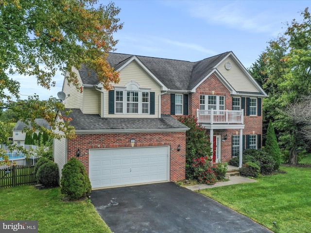 colonial house featuring brick siding, an attached garage, fence, a balcony, and a front lawn