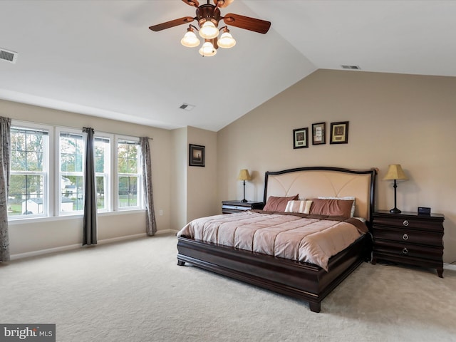 carpeted bedroom featuring visible vents, vaulted ceiling, and baseboards