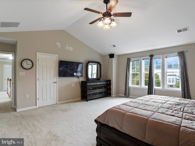 bedroom with light colored carpet, visible vents, and vaulted ceiling