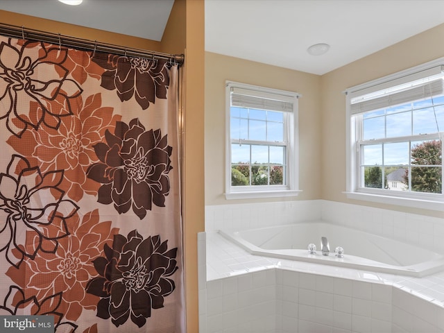 bathroom with a garden tub and a shower with shower curtain