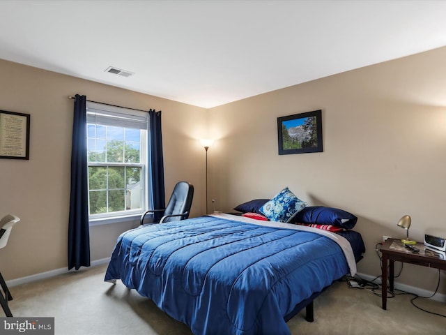 carpeted bedroom with visible vents and baseboards