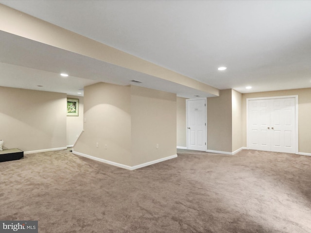 finished below grade area with recessed lighting, carpet flooring, visible vents, and baseboards