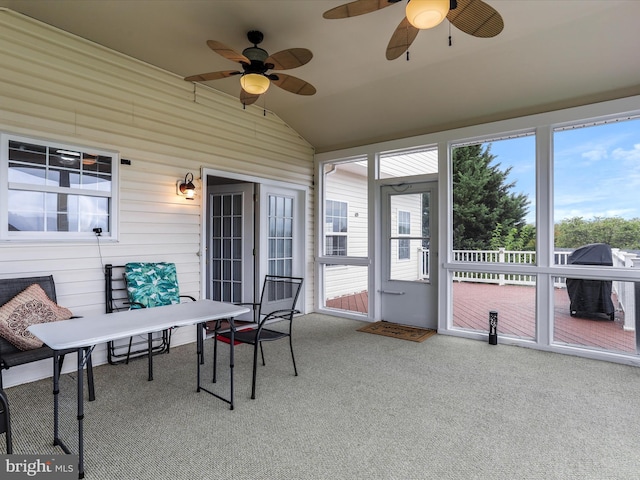 sunroom / solarium featuring lofted ceiling and ceiling fan