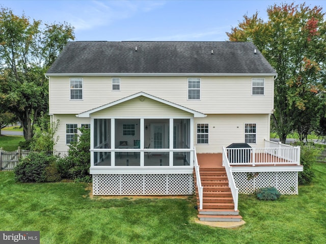 back of house featuring a deck, fence, a sunroom, stairs, and a yard