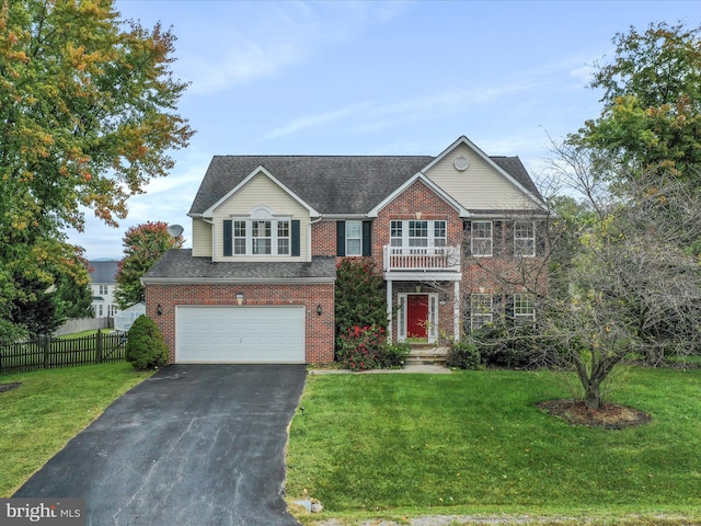 colonial home with a front yard, brick siding, and fence